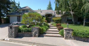 The front of a house that utilizes both landscaping and hardscaping techniques. The combination makes for a beautiful home.